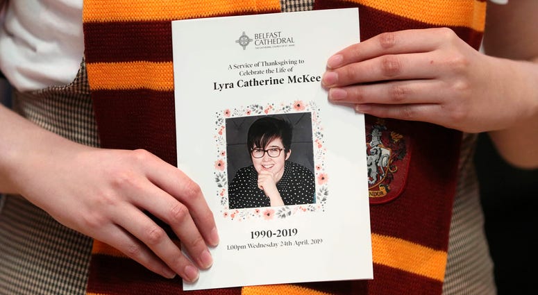 A mourner wearing a Harry Potter Gryffindor House scarf holds an order of service as she arrives for the funeral of slain journalist Lyra McKee at St Anne's Cathedral in Belfast, Northern Ireland, Wednesday April 24, 2019. Lyra McKee funeral