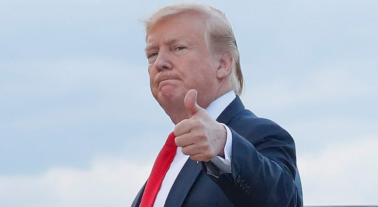 In this April 21, 2019 photo, President Donald Trump gives a 'thumbs-up' as he walks across the tarmac during his arrival on Air Force One at Andrews Air Force Base, Md. President Donald Trump
