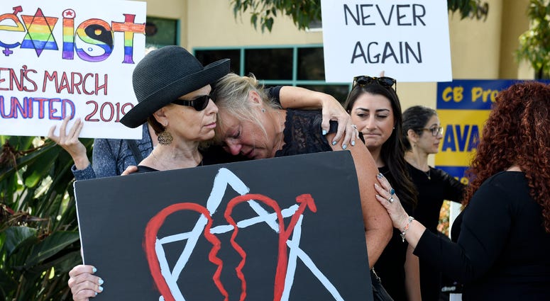 Leslie Gollub, left, and Gretchen Gordon hug at a vigil held to support the victims of the Chabad of Poway synagogue shooting, Sunday, April 28, 2019, in Poway, Calif. Poway, California synagogue shooting