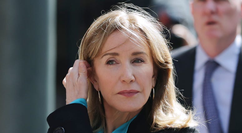 In this April 3, 2019 file photo, actress Felicity Huffman arrives at federal court in Boston to face charges in a nationwide college admissions bribery scandal. Felicity Huffman