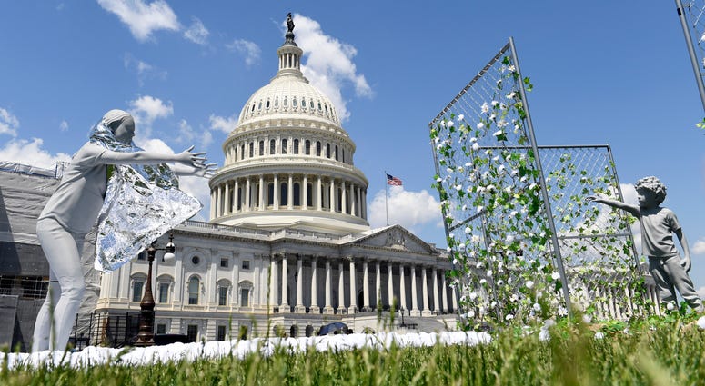 An art installation, on display outside the Capitol in Washington, Tuesday, May 7, 2019, shows a mother reaching out to her child to mark the first anniversary of the Trump administration's "zero tolerance" family separation policy. An art installation