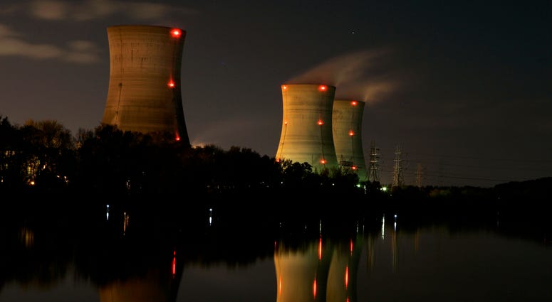 In this Nov. 2, 2006, file photo, cooling towers of the Three Mile Island nuclear power plant are reflected in the Susquehanna River in this image taken with a slow shutter speed in Middletown, Pa. Three Mile Island
