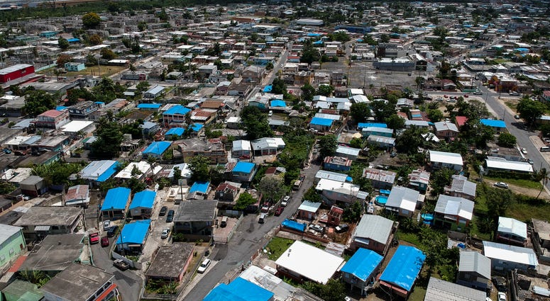 This June 18, 2018, file photo shows an aerial view of the Amelia neighborhood in the municipality of Catano, east of San Juan, Puerto Rico. This June 18, 2018, file photo shows an aerial view of the Amelia neighborhood in the municipality of Catano, east of San Juan, Puerto Rico.