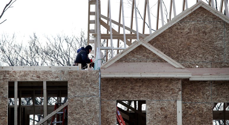 In this Jan. 23, 2019, file photo, construction workers build new housing in Salisbury, Mass. Construction workers build new housing.