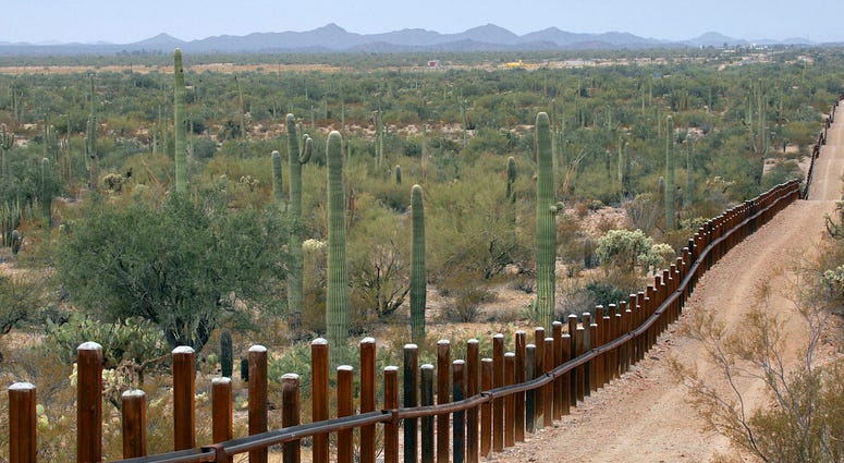 This Feb. 17, 2006 file photo shows the international border line made up of bollards: irregular, concrete-filled steel poles, seperating Mexico, left from the United States, in the Organ Pipe National Monument near Lukeville, Ariz. International border line