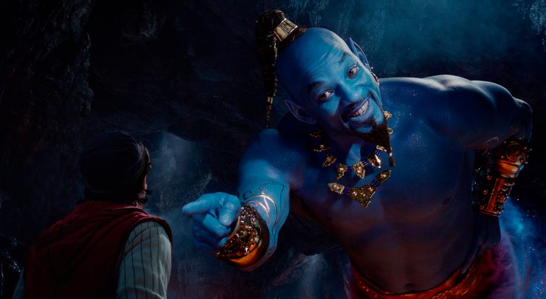 This image released by Disney shows Mena Massoud as Aladdin, left, and Will Smith as Genie in Disney's live-action adaptation of the 1992 animated classic "Aladdin." "Aladdin"