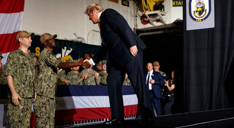 President Donald Trump arrives on stage to speak to troops at a Memorial Day event aboard the USS Wasp, Tuesday, May 28, 2019, in Yokosuka, Japan. President Donald Trump