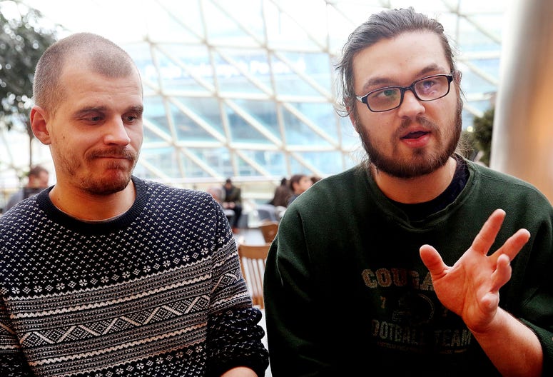 In this Friday, Jan. 19, 2018 photo two Belrusian men, Adam Bialiatski, left and Mikita Valadzko, right, speak to The Associated Press in Warsaw, Poland. Adam Bialiatski and Mikita Valadzko