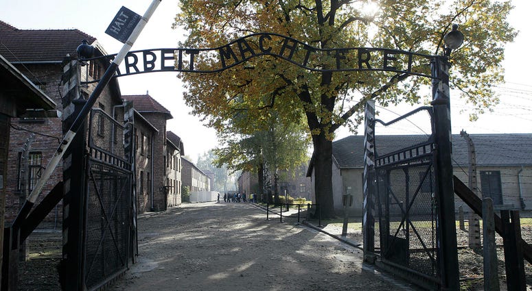 This Friday, Oct. 19, 2012 photo shows the entrance to the former Nazi German Auschwitz death camp with the inscription 'Arbeit Macht Frei' (Work Sets You Free) in Oswiecim, Poland. Auschwitz