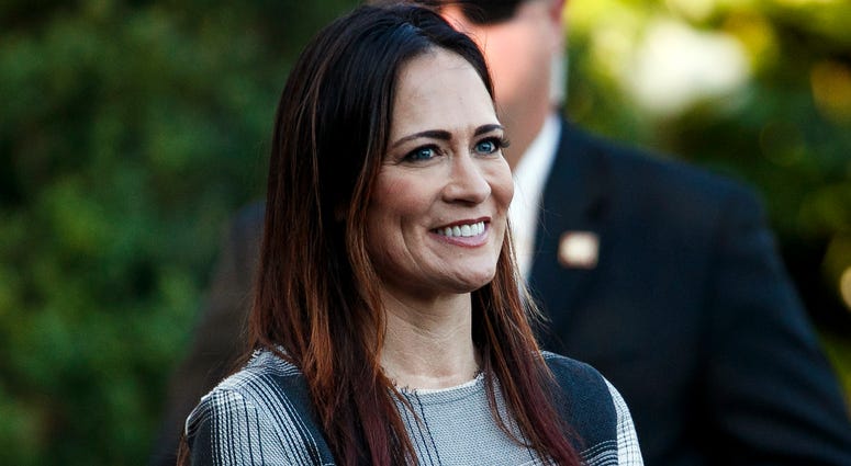 In this June 21, 2019 photo, Stephanie Grisham, spokeswoman for first lady Melania Trump, watches as President Donald Trump and the first lady greet attendees during the annual Congressional Picnic on the South Lawn in Washington. Stephanie Grisham