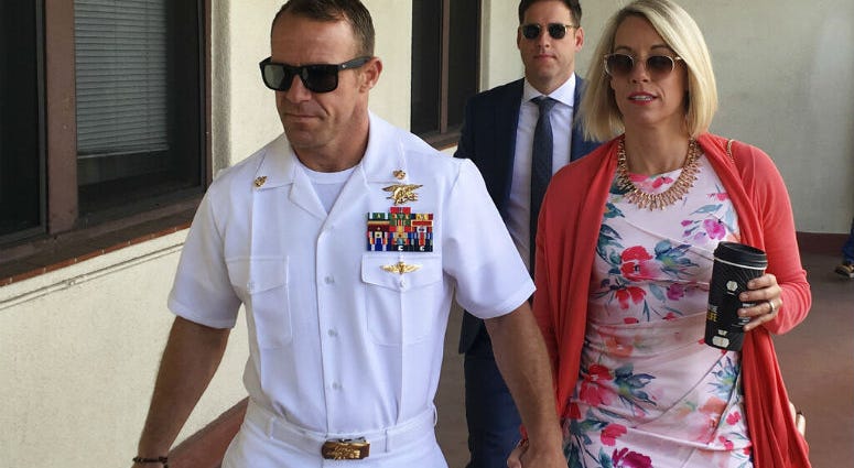 Navy Special Operations Chief Edward Gallagher, left, walks with his wife, Andrea Gallagher as they arrive to military court on Naval Base San Diego, Monday, July 1, 2019, in San Diego. The trial continued Monday in the court-martial of the decorated Navy SEAL, who is accused of stabbing to death a wounded teenage Islamic State prisoner and wounding two civilians in Iraq in 2017.