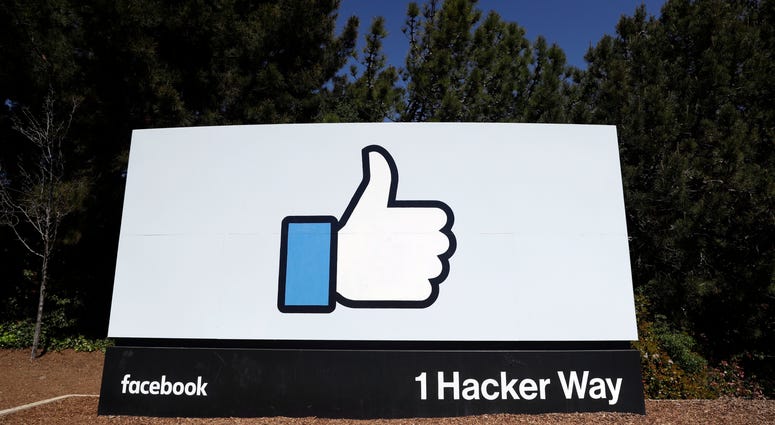The Facebook logo is shown on a sign at the company's headquarters in Menlo Park, Calif. Facebook