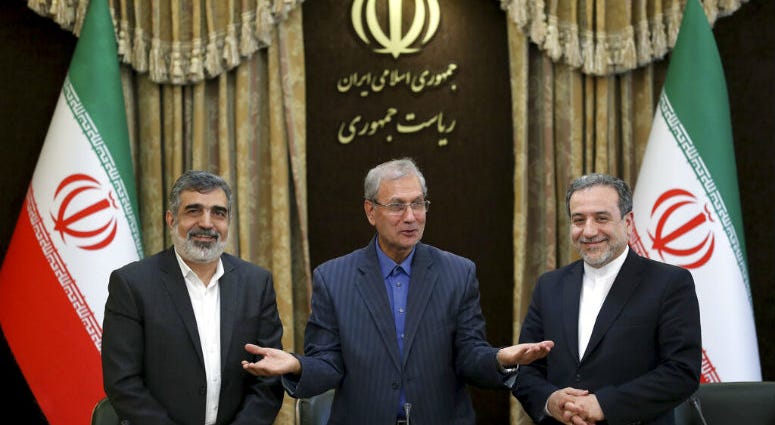 From left to right, spokesman for Iran's atomic agency Behrouz Kamalvandi, Iran's government spokesman Ali Rabiei and Iranian Deputy Foreign Minister Abbas Araghchi, attend a press briefing in Tehran, Iran, Sunday, July 7, 2019. The deputy foreign minister says that his nation considers the 2015 nuclear deal with world powers to be a "valid document" and seeks its continuation.