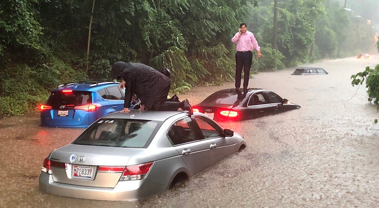 Motorists are stranded on a flooded section of Canal Road in Washington during a heavy rainstorm, Monday, July 8, 2019. Flooding
