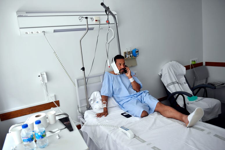 Jaime Alvarez from Santa Clara County, California, sits in a hospital in Pamplona, northern Spain, Monday, July 8, 2019 after being gored by a bull Sunday at the San Fermin Festival. Jaime Alvarez
