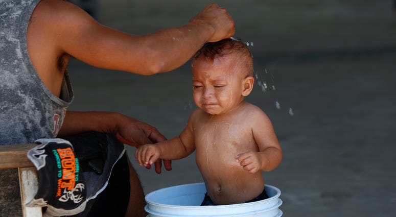 A migrant baby is given a bath at the AMAR migrant shelter in Nuevo Laredo, Mexico, Tuesday, July 16, 2019. A migrant baby is given a bath at the AMAR migrant shelter in Nuevo Laredo, Mexico, Tuesday, July 16, 2019.