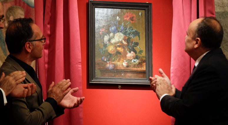 German Foreign Minister Heiko Mass, left, and Italian Culture Minister Alberto Bonisoli watch the unveiling of the "Vase of Flowers" painting by Jan van Huysum, at the Pitti Palace, part of the Uffizi Galleries, in Florence, Italy, Friday, July 19, 2019. German Foreign Minister Heiko Mass, left, and Italian Culture Minister Alberto Bonisoli watch the unveiling of the "Vase of Flowers" painting by Jan van Huysum, at the Pitti Palace, part of the Uffizi Galleries, in Florence, Italy, Friday, July 19, 2019.