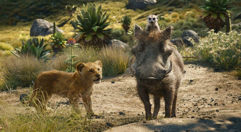 FILE - This file image released by Disney shows, from left, young Simba, voiced by JD McCrary, Timon, voiced by Billy Eichner, and Pumbaa, voiced by Seth Rogen, in a scene from "The Lion King." The Walt Disney Co. is ruling the box office again with the record-breaking debut of “The Lion King” this weekend.