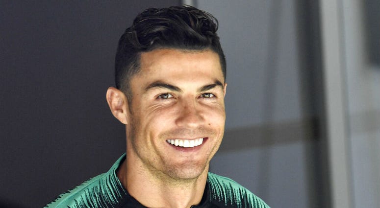 FILE - In this June 8, 2019, file photo, Portugal's Cristiano Ronaldo smiles when he arrives to a training session at the Bessa stadium in Porto, Portugal. Soccer star Cristiano Ronaldo won’t face criminal charges after a woman accused him of raping her at a Las Vegas Strip resort in 2009.