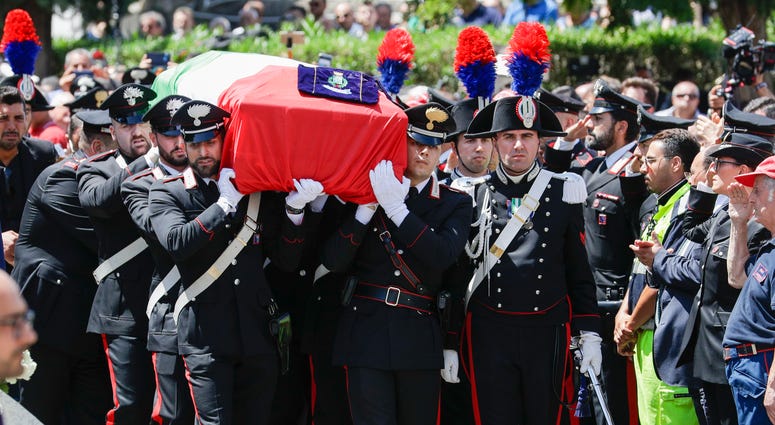 The coffin containing the body of Carabinieri's officer Mario Cerciello Rega is carried to his funeral in his hometown of Somma Vesuviana, near Naples, southern Italy, Monday, July 29, 2019. Funeral of Carabinieri's officer Mario Cerciello Rega
