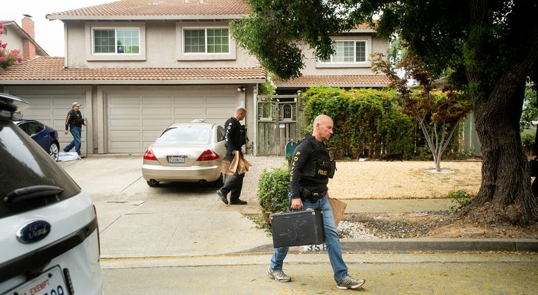 Police officers carry evidence bags from the family home of Gilroy Garlic Festival gunman Santino William Legan, Monday, July, 29, 2019, in Gilroy, Calif. Police search home of Santino William Legan.