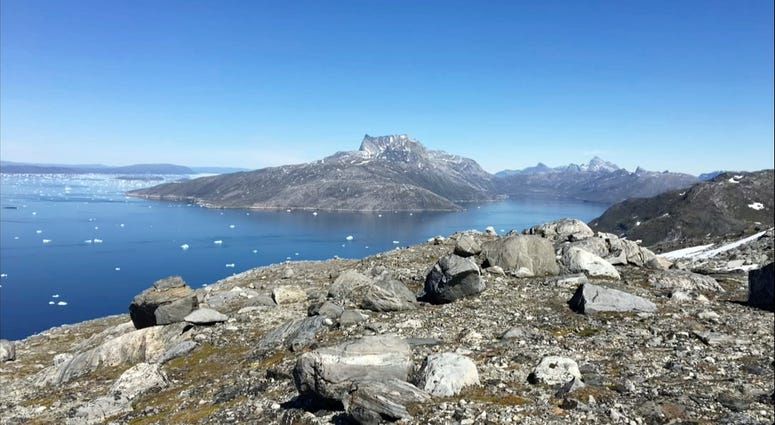 In this image taken on June 15, 2019 small pieces of ice float in the water in Nuuk Fjord, Greenland. In this image taken on June 15, 2019 small pieces of ice float in the water in Nuuk Fjord, Greenland.