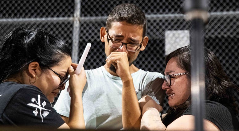 Three Walmart workers, Melisa Gonzalez, Jesus Romero and Raven Ramos, who helped people to escape during the mass shooting on Saturday, Aug. 3, 2019, get emotional during during a vigil at Ponder Park in honor of the shooting victims in El Paso, Texas. Three Walmart workers, Melisa Gonzalez, Jesus Romero and Raven Ramos, who helped people to escape during the mass shooting on Saturday, Aug. 3, 2019, get emotional during during a vigil at Ponder Park in honor of the shooting victims in El Paso, Texas.