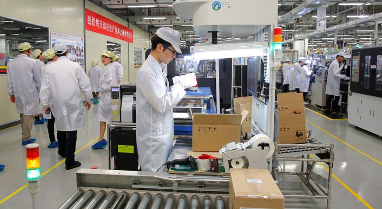 A staff member works on a mobile phone production line during a media tour in Huawei factory in Dongguan, China's Guangdong province. A staff member works on a mobile phone production line during a media tour in Huawei factory in Dongguan, China's Guangdong province.