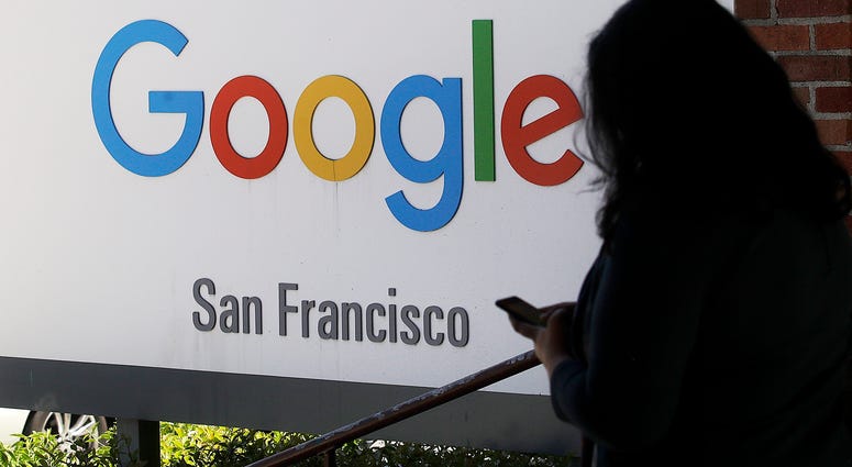 In this May 1, 2019, file photo, a person walks past a Google sign in San Francisco. In this May 1, 2019, file photo, a person walks past a Google sign in San Francisco.