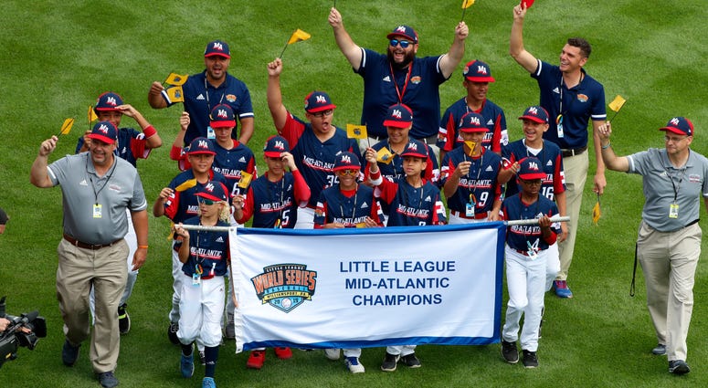 In this Aug. 15, 2019, file photo, the Mid-Atlantic Region Champion Little League team from Elizabeth, N.J. participates in the opening ceremony of the 2019 Little League World Series baseball tournament in South Williamsport, Pa. In this Aug. 15, 2019, file photo, the Mid-Atlantic Region Champion Little League team from Elizabeth, N.J. participates in the opening ceremony of the 2019 Little League World Series baseball tournament in South Williamsport, Pa.