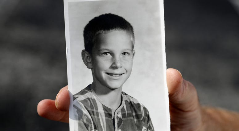 In this Wednesday, Aug. 21, 2019 photo, Greg Hunt holds a school photo of himself in St. Petersburg, Fla. Greg Hunt holds a school photo of himself.