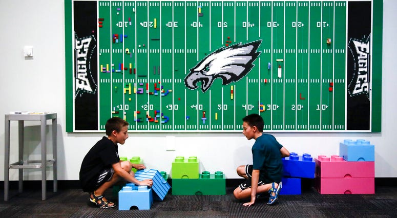 In this Thursday, Aug. 22, 2019, photo, 10-year-old twin brothers Ryan left, and Jack Ykoruk, play in the Lincoln Financial Field sensory room before a preseason NFL football game between the Philadelphia Eagles and the Baltimore Ravens in Philadelphia. Eagles Sensory
