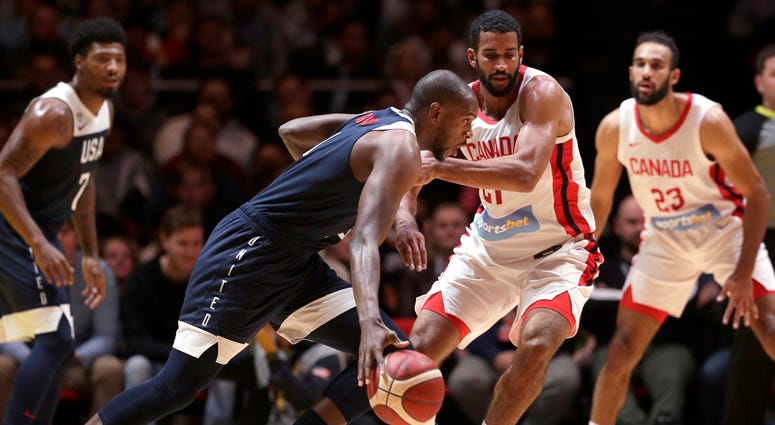 United States' Khris Middleton, second left, goes around the Canadian defenseduring their exhibition basketball game in Sydney, Australia, Monday, Aug. 26, 2019. United States' Khris Middleton, second left, goes around the Canadian defenseduring their exhibition basketball game in Sydney, Australia, Monday, Aug. 26, 2019.