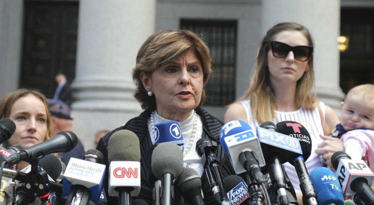 Attorney Gloria Allred, center, flanked by two of her clients, speaks during a news conference after leaving a Manhattan court where sexual victims, on invitation of a judge, addressed a hearing. 'Coward': Epstein accusers pour out their anger in court