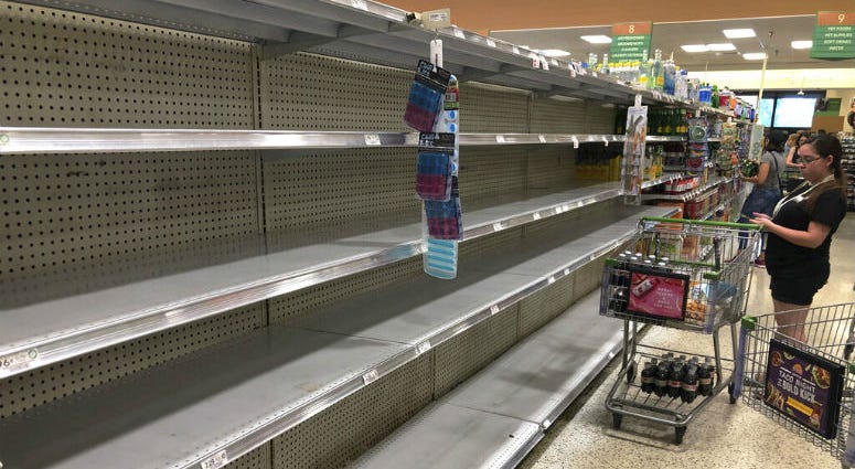 Store shelves are empty of bottled water as residents buy supplies in preparation for Hurricane Dorian, in Doral, Fla., Thursday, July 29, 2019. The U.S. National Hurricane Center says Dorian could hit the Florida coast over the weekend as a major hurricane.