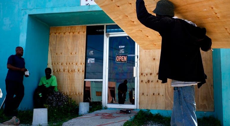 Workers board up a shop’s window front as they make preparations for the arrival of Hurricane Dorian, in Freeport, Bahamas, Friday, Aug. 30, 2019. Workers board up a shop’s window front as they make preparations for the arrival of Hurricane Dorian, in Freeport, Bahamas, Friday, Aug. 30, 2019.