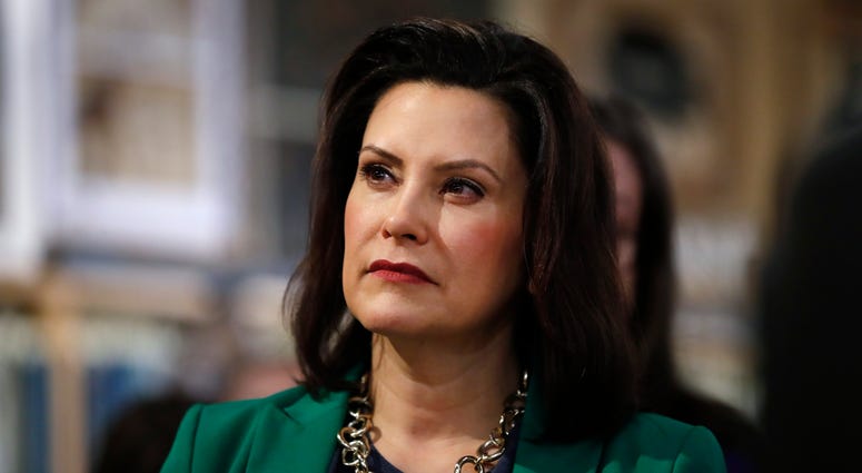 In this March 18, 2019, file photo, Michigan Gov. Gretchen Whitmer listens to Democratic presidential candidate Sen. Kirsten Gillibrand, D-N.Y., in Clawson, Mich. Michigan Gov. Gretchen Whitmer