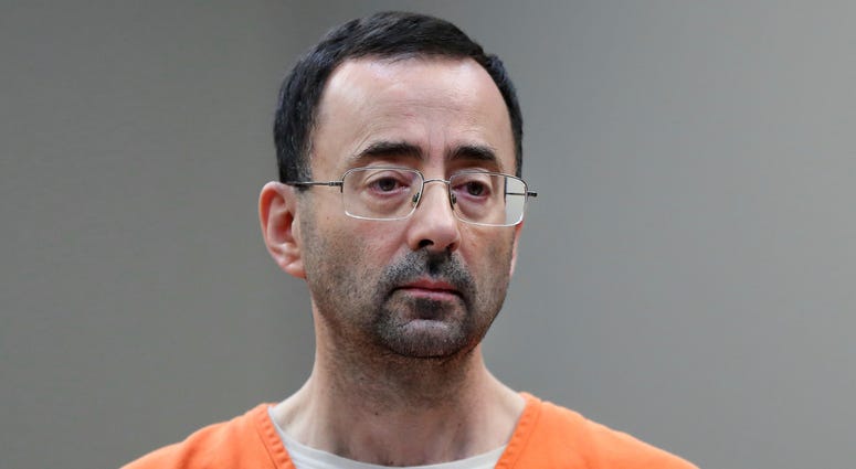 In this Nov. 22, 2017, file photo, Larry Nassar, 54, appears in court for a plea hearing in Lansing, Mich. The Education Department is fining Michigan State University $4.5 million for failing to respond to sexual assault complaints against Larry Nassar. Larry Nassar