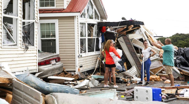 Residents of the Boardwalk RV Park discuss the path of a possible waterspout or tornado, generated by Hurricane Dorian, struck the area, Thursday, Sept. 5, 2019, in Emerald Isle, N.C. Residents of the Boardwalk RV Park discuss the path of a possible waterspout or tornado, generated by Hurricane Dorian, struck the area.