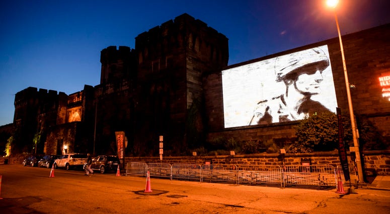A guest film by Dee Hibbert-Jones and Nomi Talisman, titled "Last Day of Freedom" is projected on the wall of Eastern State Penitentiary in Philadelphia. A guest film by Dee Hibbert-Jones and Nomi Talisman, titled "Last Day of Freedom" is projected on the wall of Eastern State Penitentiary in Philadelphia.
