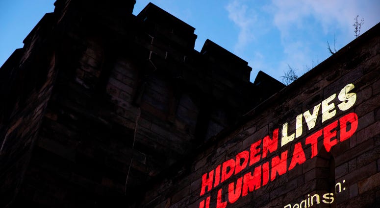 A new exhibit titled "Hidden Lives Illuminated" is projected on a wall of the Eastern State Penitentiary, a former prison that's now a museum. A new exhibit titled "Hidden Lives Illuminated" is projected on a wall of the Eastern State Penitentiary, a former prison that's now a museum.