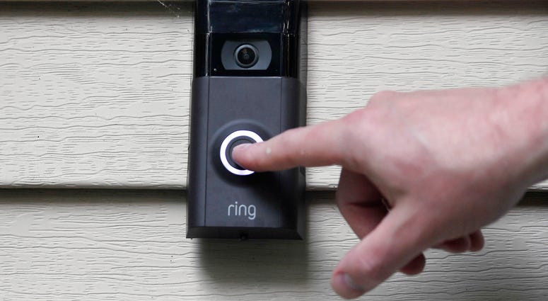 In this Tuesday, July 16, 2019, file photo, Ernie Field pushes the doorbell on his Ring doorbell camera at his home in Wolcott, Conn. Ring doorbell camera