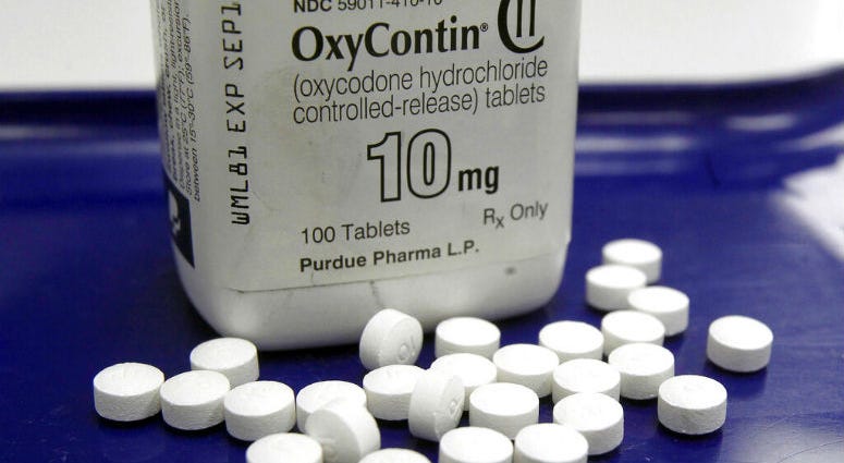 FILE - This Feb. 19, 2013, file photo shows OxyContin pills arranged for a photo at a pharmacy in Montpelier, Vt. OxyContin pills arranged for a photo at a pharmacy in Montpelier.