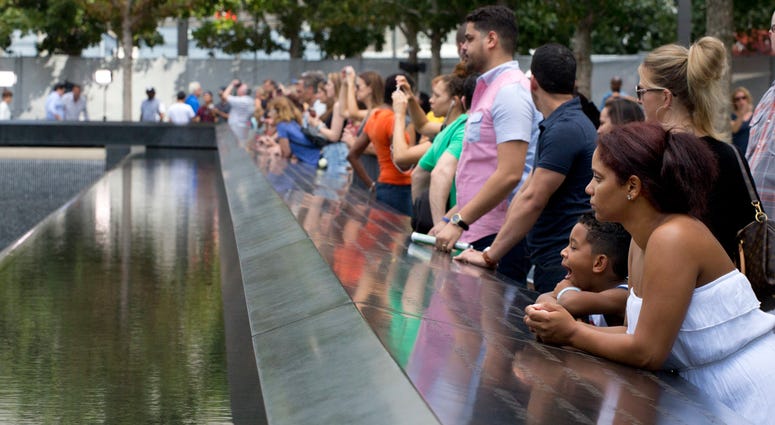 Visitors look at the waterfalls at the World Trade Center Memorial in New York. Visitors look at the waterfalls at the World Trade Center Memorial in New York.