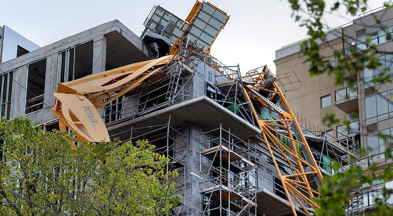 A toppled building crane is draped over a new construction project after Hurricane Dorian swept through the area in Halifax, Nova Scotia, on Sunday, Sept. 8, 2019. toppled building crane