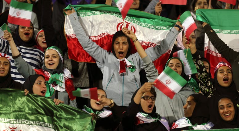 Iranian women cheer as they wave their country's flag after authorities in a rare move allowed a select group of women into Azadi stadium to watch a friendly soccer match between Iran and Bolivia, in Tehran, Iran. Iranian women cheer as they wave their country's flag after authorities in a rare move allowed a select group of women into Azadi stadium to watch a friendly soccer match between Iran and Bolivia, in Tehran, Iran.