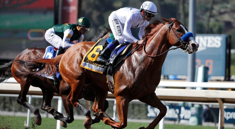 In this April 7, 2018, file photo, Justify, ridden by Mike Smith, gallops past Bolt d'Oro, left, with jockey Javier Castellano, during the Santa Anita Derby horse race at Santa Anita in Arcadia, Calif. Justify race horse