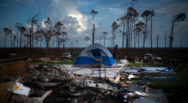 A man searches in the rubble of his house destroyed by Hurricane Dorian in Rocky Creek East, Grand Bahama, Bahamas, Thursday Sept. 12, 2019. A man searches in the rubble of his house destroyed by Hurricane Dorian in Rocky Creek East, Grand Bahama, Bahamas, Thursday Sept. 12, 2019.
