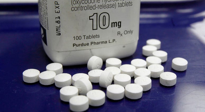 Aa pharmacist in San Francisco poses for photos holding a bottle of OxyContin. Aa pharmacist in San Francisco poses for photos holding a bottle of OxyContin.