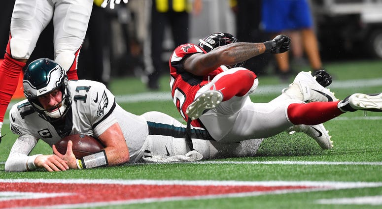 Philadelphia Eagles quarterback Carson Wentz (11) hits the turf near the goal line working for a two-point conversion against the Atlanta Falcons during the second half of an NFL football game, Sunday, Sept. 15, 2019, in Atlanta. Philadelphia Eagles quarterback Carson Wentz (11) hits the turf near the goal line working for a two-point conversion against the Atlanta Falcons during the second half of an NFL football game, Sunday, Sept. 15, 2019, in Atlanta.